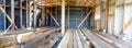 Building the frame of a wooden house. Panoramic picture inside the frame. Boards for flooring, vapor barrier walls. Royalty Free Stock Photo