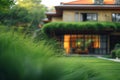 A building framed by lush green grass in a peaceful setting