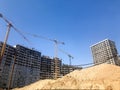 Building with the help of construction cranes of high reinforced concrete, panel, cast-frame, frame-block houses, buildings Royalty Free Stock Photo