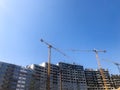 Building with the help of construction cranes of high reinforced concrete, panel, cast-frame, frame-block houses, buildings Royalty Free Stock Photo