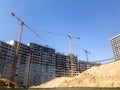 Building with the help of construction cranes of high reinforced concrete, panel, cast-frame, frame-block houses, buildings Royalty Free Stock Photo