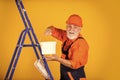 Building is his life. Craftsman With Paint Roller. House Painting and Renovation Business. making repair tool. Painter Royalty Free Stock Photo