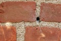 Building, hole and closeup of red, brick wall for texture, background and pattern of exterior structure. Architecture Royalty Free Stock Photo