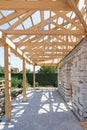 Building house from aerated concrete building blocks. New residential wooden construction home framing against a blue sky.