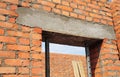 Building house construction. Window, door concrete lintel with iron bar on brick unfinished house construction.