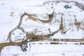 Building house foundations with pile driver machine. winter construction site. aerial top view