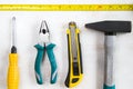 Building instrument set, tape measure, pliers, screwdriver, ruler, hammer and utility knife Royalty Free Stock Photo