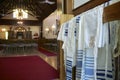 Building interior of a synagogue with a close-up of the tallit worn as a prayer shawl by religious Jews