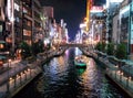 Building lights reflect off the Dotonbori Canal in Osaka, Japan.