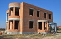 Building luxury residential brick house construction exterior without roofing