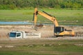 Building Machines: Digger loading trucks with soil Royalty Free Stock Photo