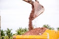 Building Machines: Digger loading trucks with soil. Excavator loading sand into a dump truck. Royalty Free Stock Photo