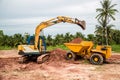 Building Machines: Digger loading trucks with soil. Excavator loading sand into a dump truck. Royalty Free Stock Photo