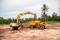 Building Machines: Digger loading trucks with soil. Excavator loading sand into a dump truck. Royalty Free Stock Photo