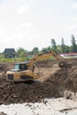 Building Machines: Digger loading trucks with soil. Excavator loading sand into a dump truck. Work in the quarry. Royalty Free Stock Photo