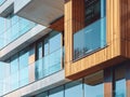 A building made of glass and wood, featuring numerous windows and a balcony Royalty Free Stock Photo