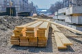 Building material in the form of fresh wooden planks on a road repair site