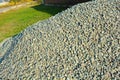 Building materials for construction and repair work, clean fine gravel rubble, a pile of building pebbles in the autumn sunlight.