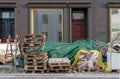 Building materials, wooden ladders, Euro pallets and bulky waste on the side of the road