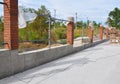 Building a Metal and Concrete, Bricks Fence with Iron Bar Royalty Free Stock Photo