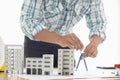 Building models and blueprints are placed on work desks in the construction engineering team offices to plan construction to