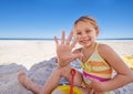 Building the most awesome sandcastle ever. A cute little girl sitting on the sand at the beach with her bucket and spade Royalty Free Stock Photo