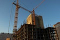 Building of a Of a multi-storey residential building with two tower cranes. Construction of a monolithic frame building.