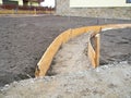 Building new concrete pavement foundation in the garden. Make foundation for paving, path Royalty Free Stock Photo