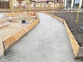 Building new concrete pavement foundation in the garden. Foundation for paving, path, walkway. Royalty Free Stock Photo