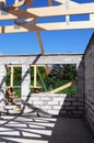 Building a new house construction with brick walls, large window and doorway frame with the view from inside unfinished house on