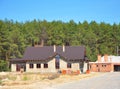 Building New Suburban House on the Forest Background. Royalty Free Stock Photo