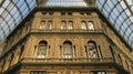 a building with ornate windows next to an iron archway ceiling