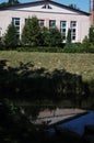 The building over the water with trees and reflection of the professional laboratory