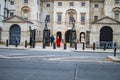 The building of palace and the security guards in red and black uniforms Royalty Free Stock Photo