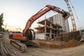 Building panorama with excavator in foreground Royalty Free Stock Photo