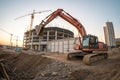 Building panorama with excavator in foreground Royalty Free Stock Photo
