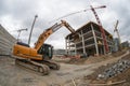 Building panorama with excavator in foreground Royalty Free Stock Photo