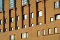 Building pattern beautiful architecture in yellow or brick color sunrise along many glasses window surrounding the building , nice Royalty Free Stock Photo