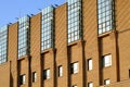 Building pattern beautiful architecture in yellow or brick color sunrise along many glasses window surrounding the building , nice Royalty Free Stock Photo