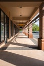 Building pillars outside corridor and glass doors. Corridor of brick columns in a modern building outdoor on sunny day Royalty Free Stock Photo