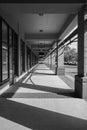 Building pillars outside corridor and glass doors. Corridor of brick columns in a modern building outdoor on sunny day Royalty Free Stock Photo