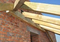 Building a pitch roof frame attaching roof rafters, trusses, beams and joists to wall plate layout and ridge board of a brick Royalty Free Stock Photo