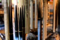 Building Pool Cue, Close-up Snookers Cue hanging in the workplace of craftsmanship factory. Soft focusing on the front cue Royalty Free Stock Photo