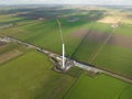 Building process of wind turbine windmill construction with cranes. Parts of the wind turbine, housing, hub, blades on Royalty Free Stock Photo