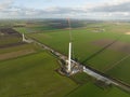 Building process of wind turbine windmill construction with cranes. Parts of the wind turbine, housing, hub, blades on Royalty Free Stock Photo