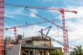 Building red crane and building under construction against blue sky Royalty Free Stock Photo