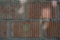 Building red embossed brick, building brick wall, structural background. Royalty Free Stock Photo