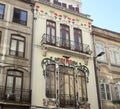 Building with red and green flowers and windows Royalty Free Stock Photo