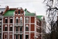 A building of red and white brick with large windows. Russia Yoshkar Ola 01.05.2021