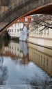 Building reflection in water under bridge Royalty Free Stock Photo